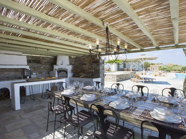 The shady al fresco kitchen and dining area, complete with pizza oven and barbecue.
